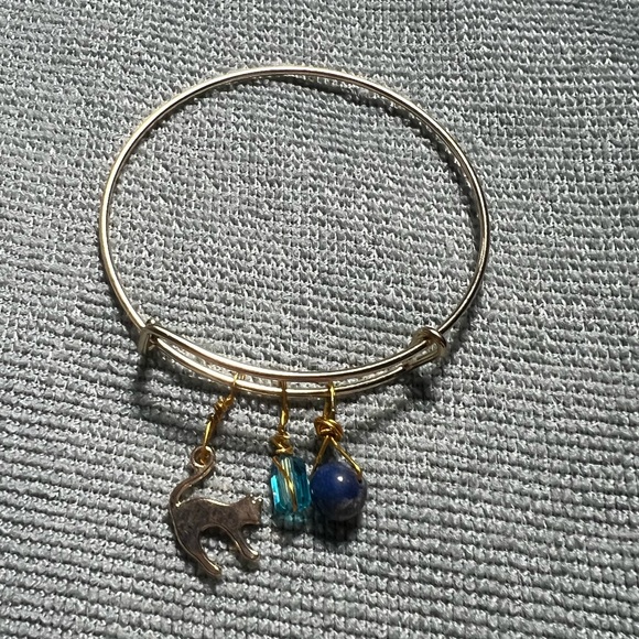 gold metal bracelet with cat, bead, & blue gemstone charms - Picture 2 of 5